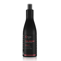 A black spray bottle with red and white labeling for 'Orgie' brand hair and body lotion.