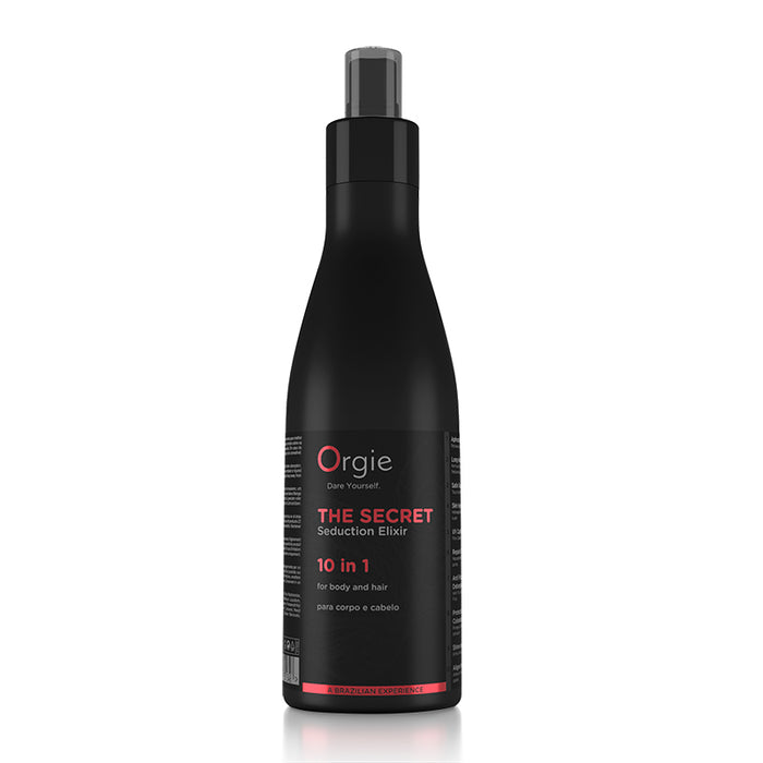 A black spray bottle with red and white labeling for 'Orgie' brand hair and body lotion.