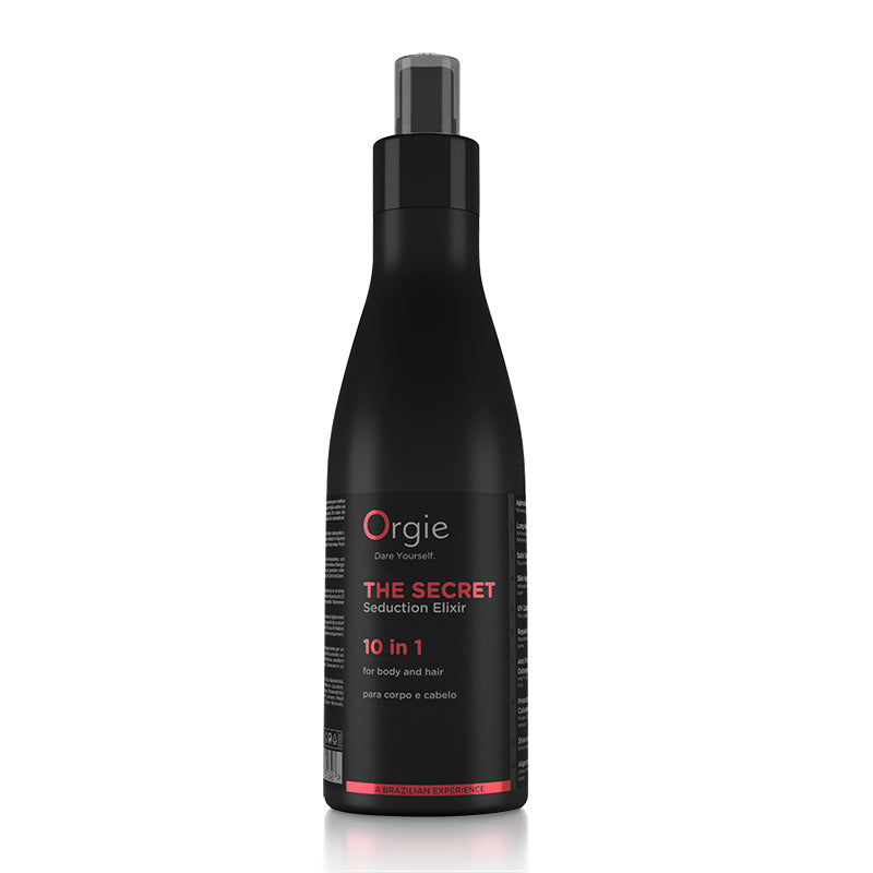 A black spray bottle with red and white labeling for 'Orgie' brand hair and body lotion.