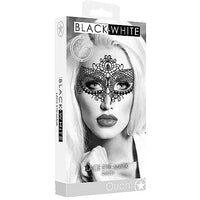 A black and white lace eye mask displayed in its packaging, which features an image of a woman wearing the mask. The mask has a intricate, elegant design with a crown-like top and delicate lace details.