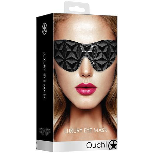 A packaged luxury eye mask with a diamond pattern, displayed on a box showing a model wearing the product.