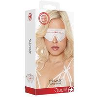 The product image shows the packaging of a white eye mask with a nurse-themed design, featuring a woman in a white nursing uniform on the box. The eye mask has ear pieces and a strap for securing.