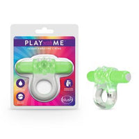The image shows a green and white vibrating cock ring, along with its packaging. The packaging has the text 'PLAY with ME' and highlights features such as being waterproof and phthalate-free.