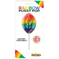 The image displays a packaged Rainbow Pussy Shaped Lollipop. The lollipop itself is vividly colored with bands of red, orange, yellow, green, blue, and purple, giving it a bright and eye-catching appearance.