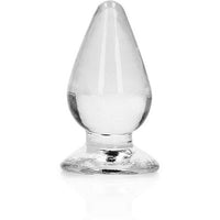 A clear anal plug with a tapered shape and a suction cup base.