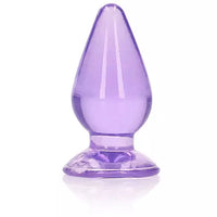 A purple anal plug with a tapered shape and a suction cup base.