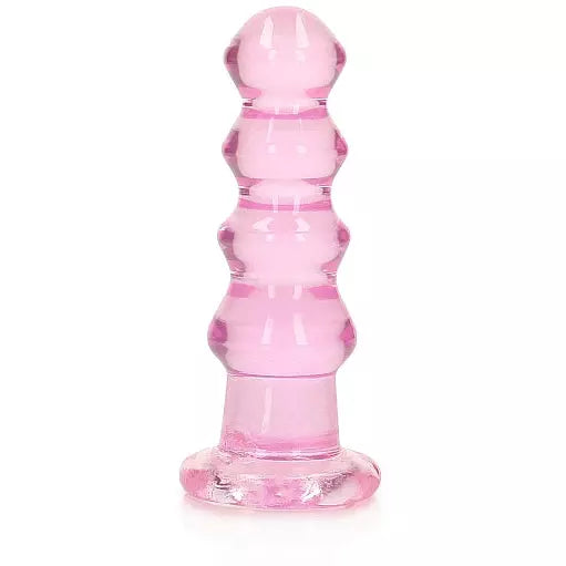 A pink, crystal-clear anal plug with a curved, bead-like design and a suction cup base.