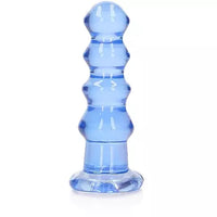 A blue, crystal-clear anal plug with a curved, bead-like design and a suction cup base.