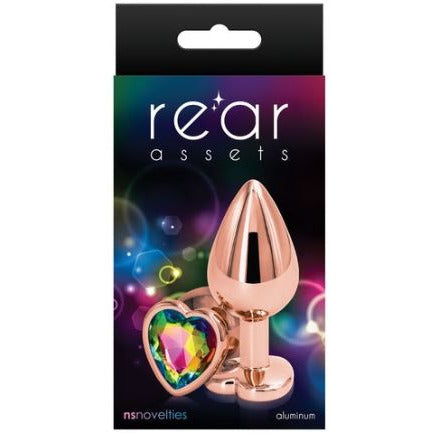 The product is an anal plug with a chrome-plated finish and a heart-shaped gem at the base. It is shown in its packaging, which is black with a space-themed background.