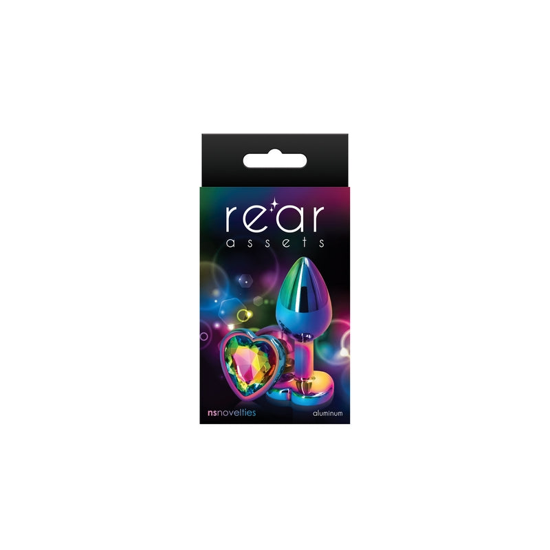 The product image shows a package with the branding 'Rear Assets' featuring a heart-shaped, multicolored anal plug. The packaging is predominantly black with purple and pink accents, highlighting the product's aesthetic appeal.