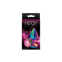 The product is an anal plug with a chrome-plated finish, featuring a teardrop shape with a colorful gem at the base. It is shown in packaging that reads 'Rear Assets'.