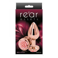 The product image shows a shiny, gold-colored anal plug with a rose-shaped base, presented in a package with a red and black design.