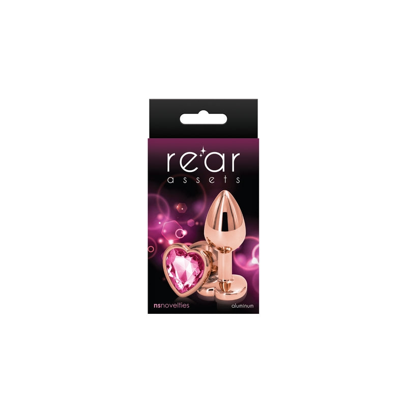 The product image shows a packaged anal plug with a heart-shaped pink tip. The plug has a metallic, chrome-plated finish and is displayed in its retail packaging, which is black with a purple and pink backdrop.