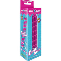 The image displays the Rock Candy Sugar Daddy Dildo in its packaging. The packaging is vibrant with a predominantly pink and blue color scheme, featuring images of the product, which is a blue silicone dildo with a twisted shaft and a realistic head.