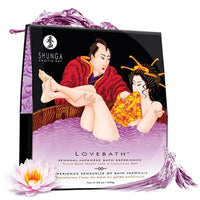 Packaging of Love Bath Crystals Sensual Lotus by Shunga featuring an illustration of a couple in a bathtub and lotus flowers.