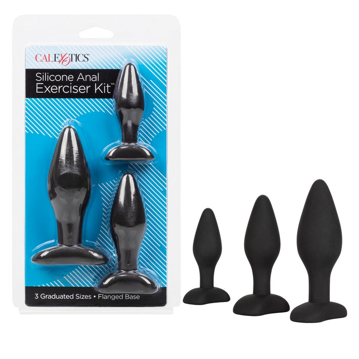 The image shows a set of three black silicone anal plugs with flanged bases, packaged in clear plastic with blue accents. The product is labeled as the 'Silicone Anal Exerciser Kit 3pk by Cal Exotics'.