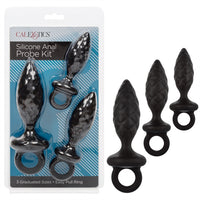 The image shows a black silicone anal probe kit with three graduated sizes, each featuring a tapered design and an easy pull ring. The probes are displayed both in their packaging and separately.