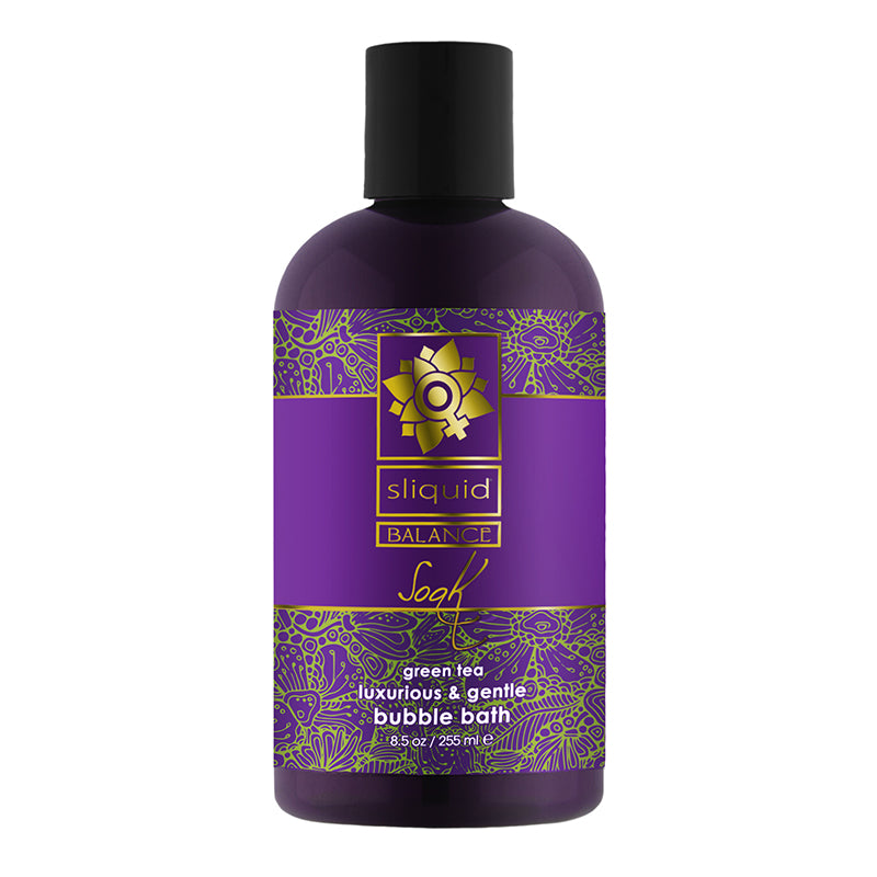 A bottle of Sliquid Soak bubble bath in green tea scent, with purple packaging and floral designs.