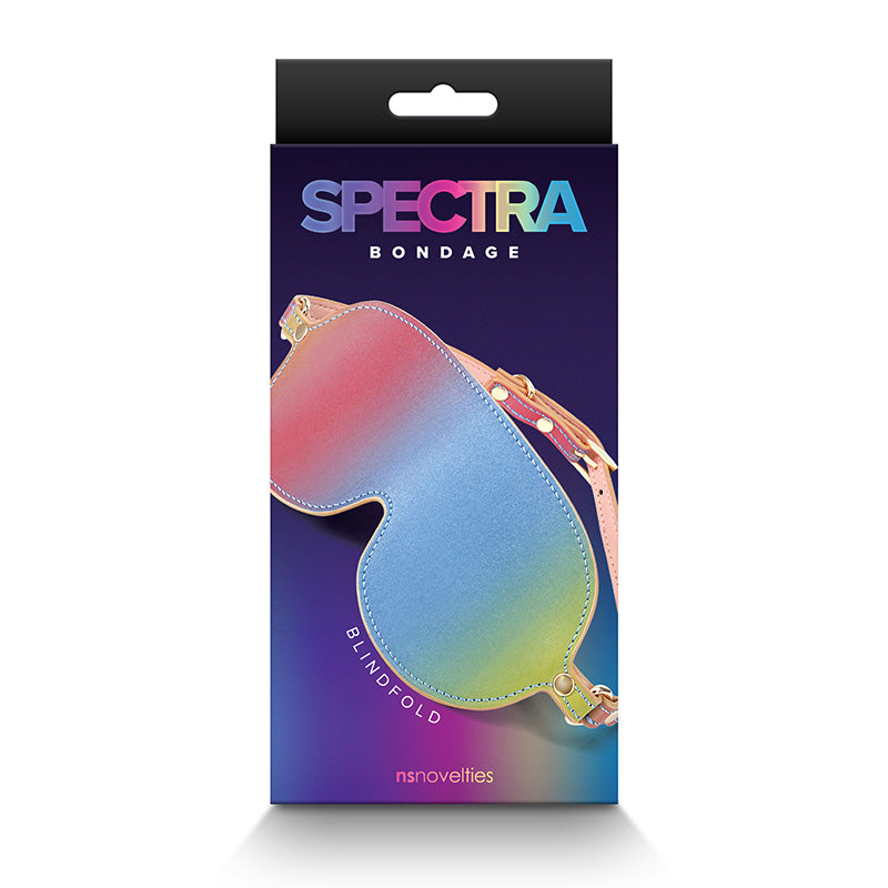 The product image shows the packaging of the Spectra Bondage Blindfold, with the blindfold itself displayed in a colorful, heart-shaped design on the front. The packaging is vibrant with a multicolored background and the brand name 'Spectra' is prominently featured.