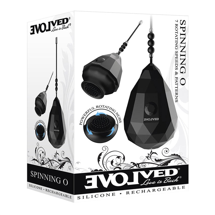 The product image shows the packaging of the Spinning O Rechargeable, featuring a black diamond-textured egg and a spinning silicone brush with nubs. The box highlights features like the powerful motor, LED illumination, and magnetic rechargeability.