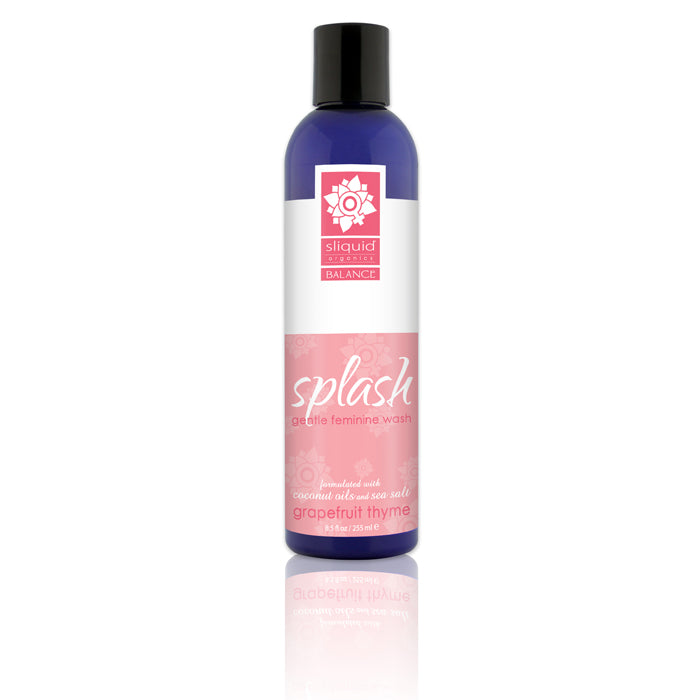 A bottle of Sliquid Splash Feminine Wash with a label that has a floral design and indicates the fragrance is Grapefruit Thyme.