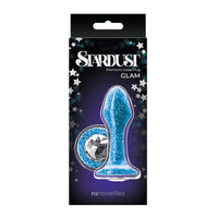 The product image shows the Stardust anal plug in its packaging. The plug is blue with glitter and colored crystal accents, and the packaging is black with star decorations.