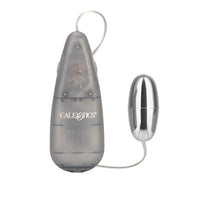 The image shows a compact and sleek Vibrating Slim Bullet in a smoke color with silver plating on the bullet itself. The controller is a slim, teardrop-shaped device with a button interface and a small display indicating the current vibration setting.
