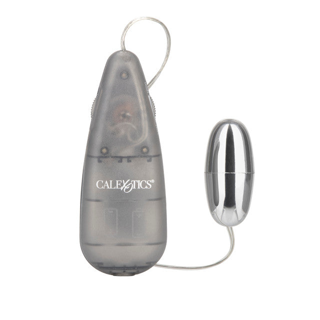 The image shows a compact and sleek Vibrating Slim Bullet in a smoke color with silver plating on the bullet itself. The controller is a slim, teardrop-shaped device with a button interface and a small display indicating the current vibration setting.