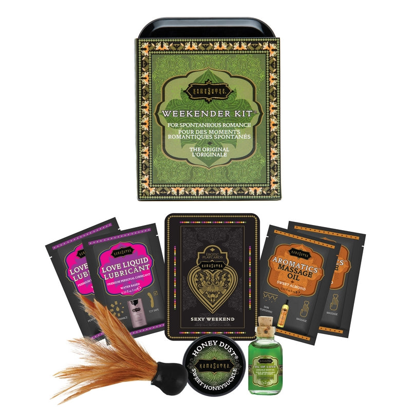 The image displays the Kama Sutra Weekender Kit Original, presented in a black and green keepsake tin with various romance-enhancing products arranged neatly around it. The products include small packets of lubricant, body oil, body powder with a feather tickler, massage oil, and erotic playcards.